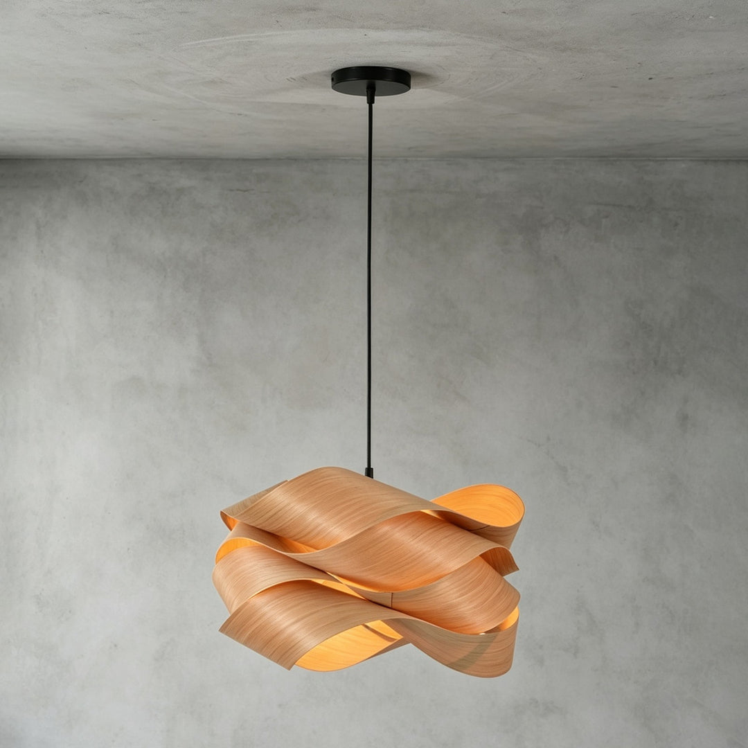 Link wood pendant light with a black canopy installed against a gray concrete wall