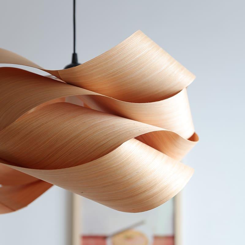 Side detail of the Link pendant light showing smooth curved wood veneer layers