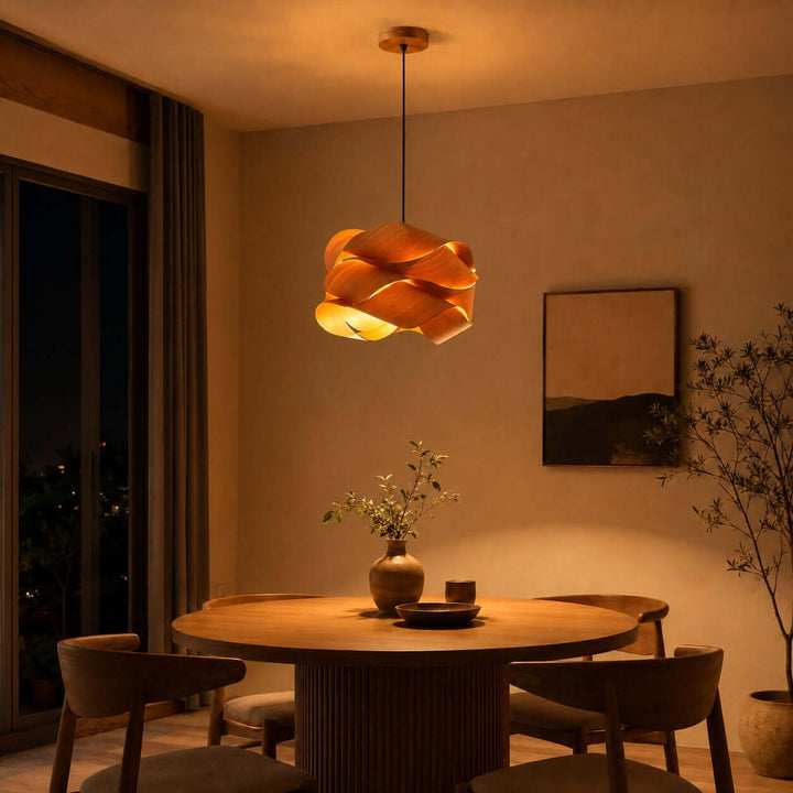 Glowing Link wood pendant light casting warm light over a round dining table at night