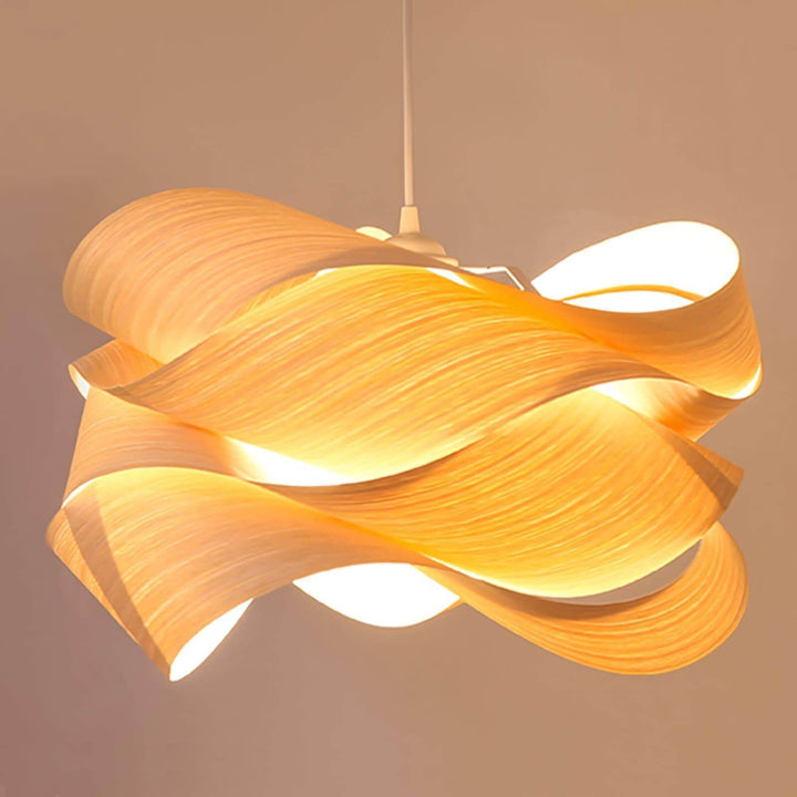Close view of the illuminated Link pendant light with sculptural wood veneer curves