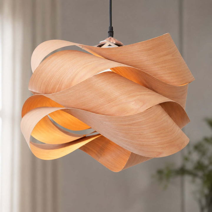 Close-up of the Link pendant light showing layered curved wood veneer ribbons