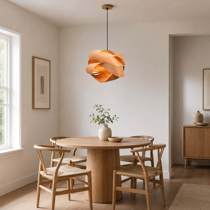Link wood pendant light centered above a round table in a minimalist dining room