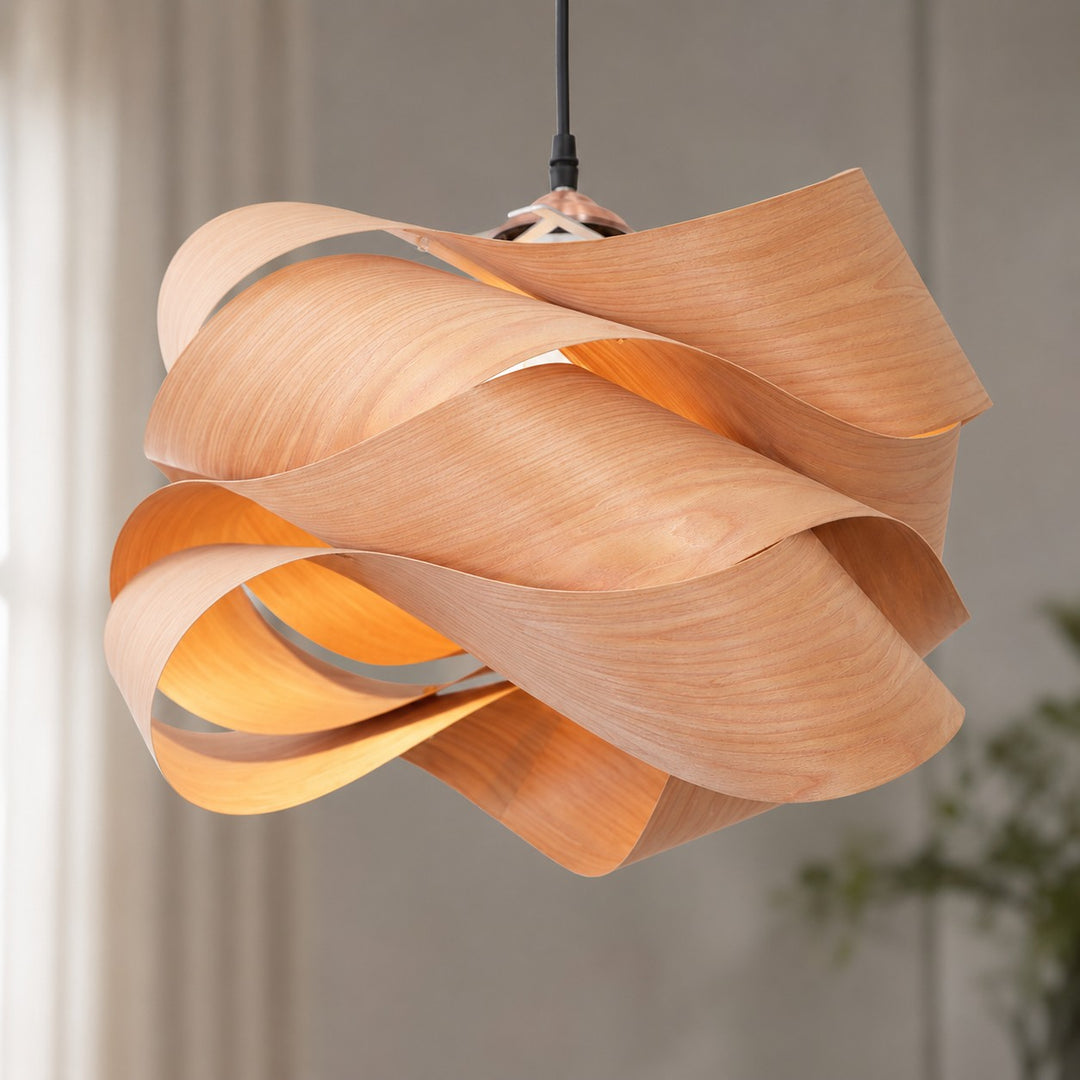 Detailed view of the Link pendant light’s flowing layered wood shade and black cord