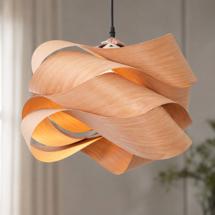 Detailed view of the Link pendant light’s flowing layered wood shade and black cord