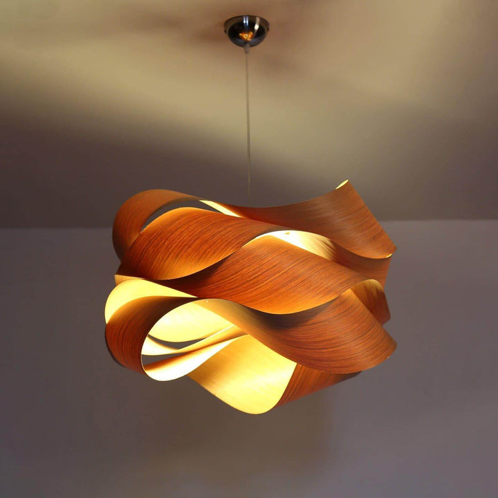 Warm illuminated Link pendant light viewed from below with its ceiling canopy visible