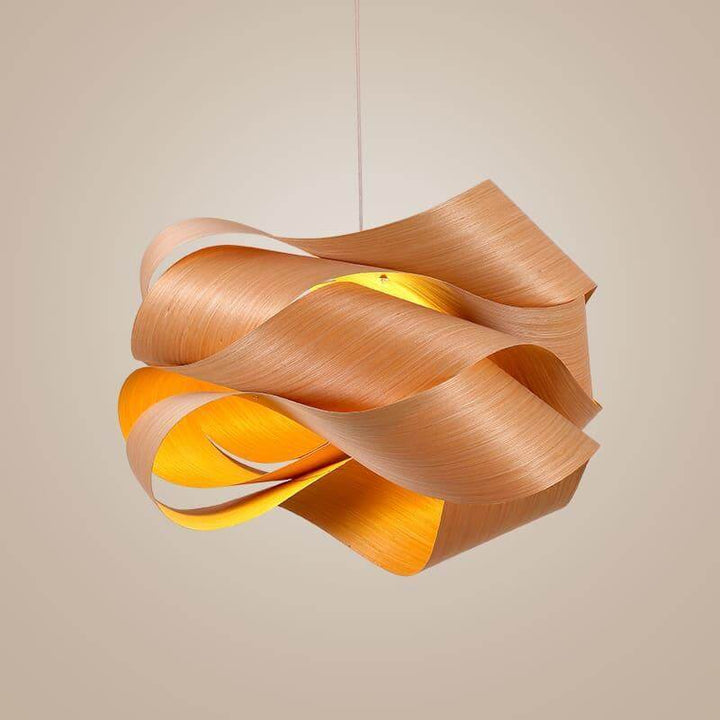 Illuminated Link wood pendant light with a warm glow against a neutral background