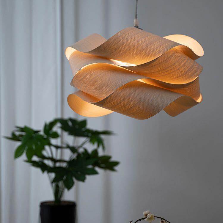 Glowing Link pendant light near a window with a leafy plant in the background