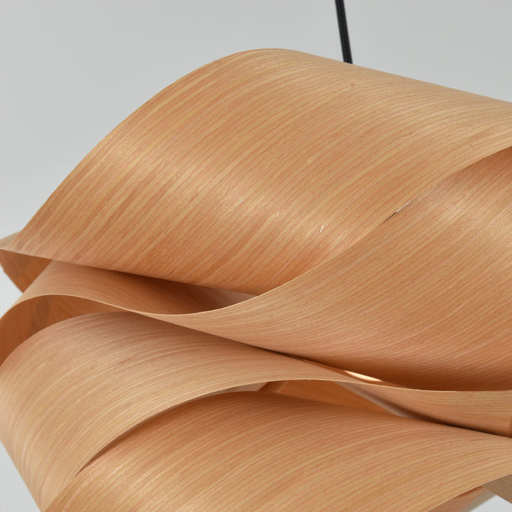 Extreme close-up of the Link pendant light’s natural wood grain and overlapping shade panels