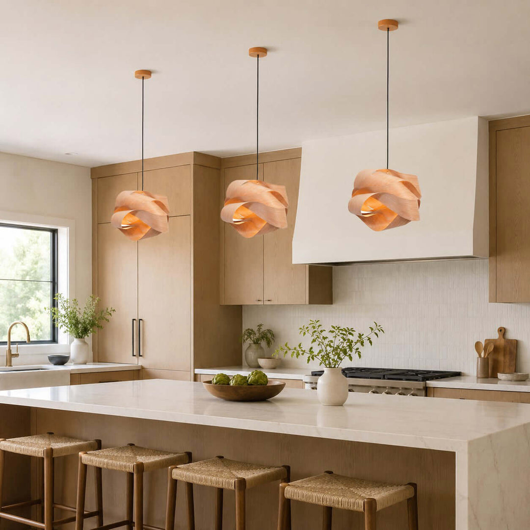 Three Link wood pendant lights above a large white kitchen island