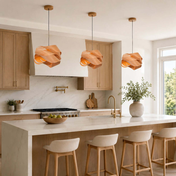 Three Link wood pendant lights illuminating a marble kitchen island in a modern kitchen