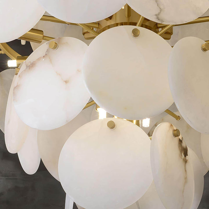 Close-up of a multi-tiered alabaster chandelier with circular alabaster discs, perfect for mid-century modern living room decor.