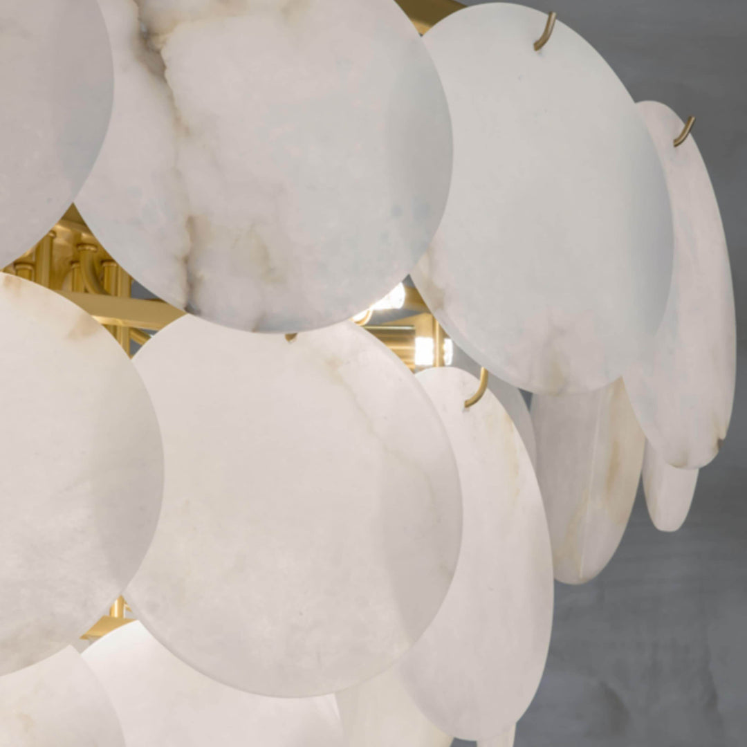 Close-up of a marble multi-tiered round chandelier featuring alabaster patterns, ideal for mid-century modern living room decor.