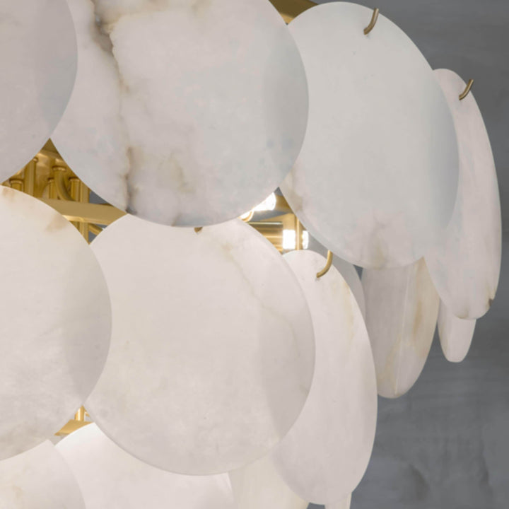 Close-up of a marble multi-tiered round chandelier featuring alabaster patterns, ideal for mid-century modern living room decor.