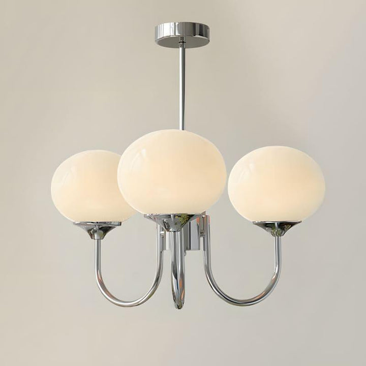 Three-light Marshmallow chandelier with a chrome frame and cream glass globes.