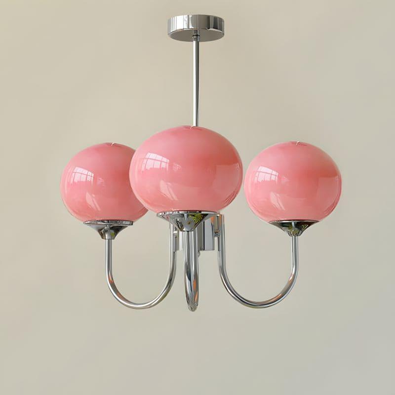Three-light Marshmallow chandelier with a chrome frame and pink glass globes.
