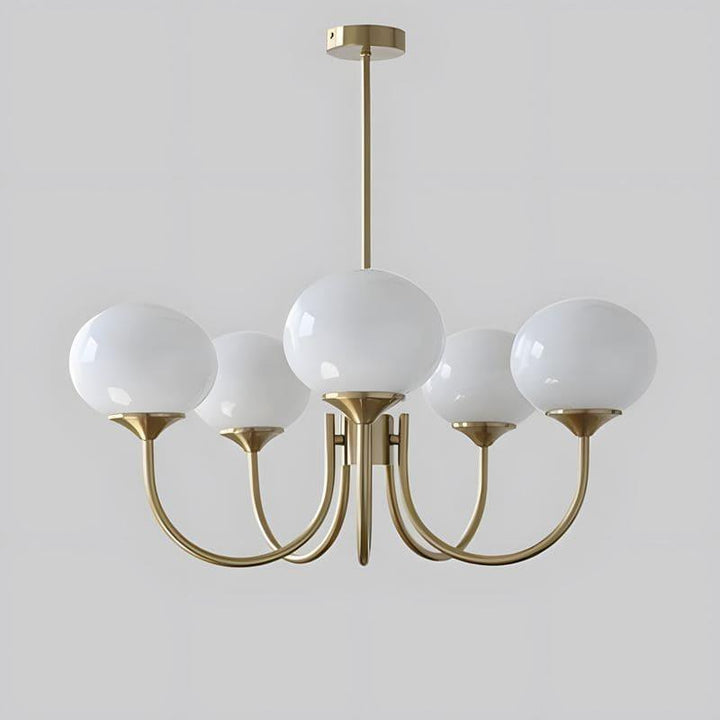 Five-light Marshmallow chandelier with a copper frame and white glass globes.
