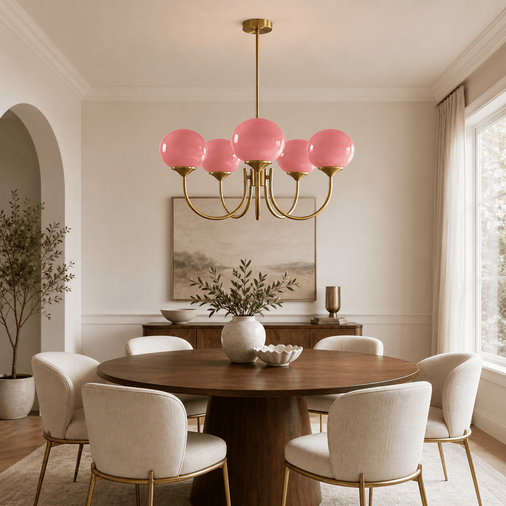 Five-light Marshmallow pink glass chandelier above a round table in a modern dining room.
