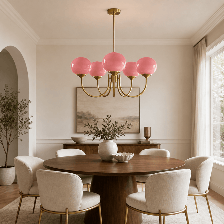 Five-light Marshmallow pink glass chandelier above a round table in a modern dining room.
