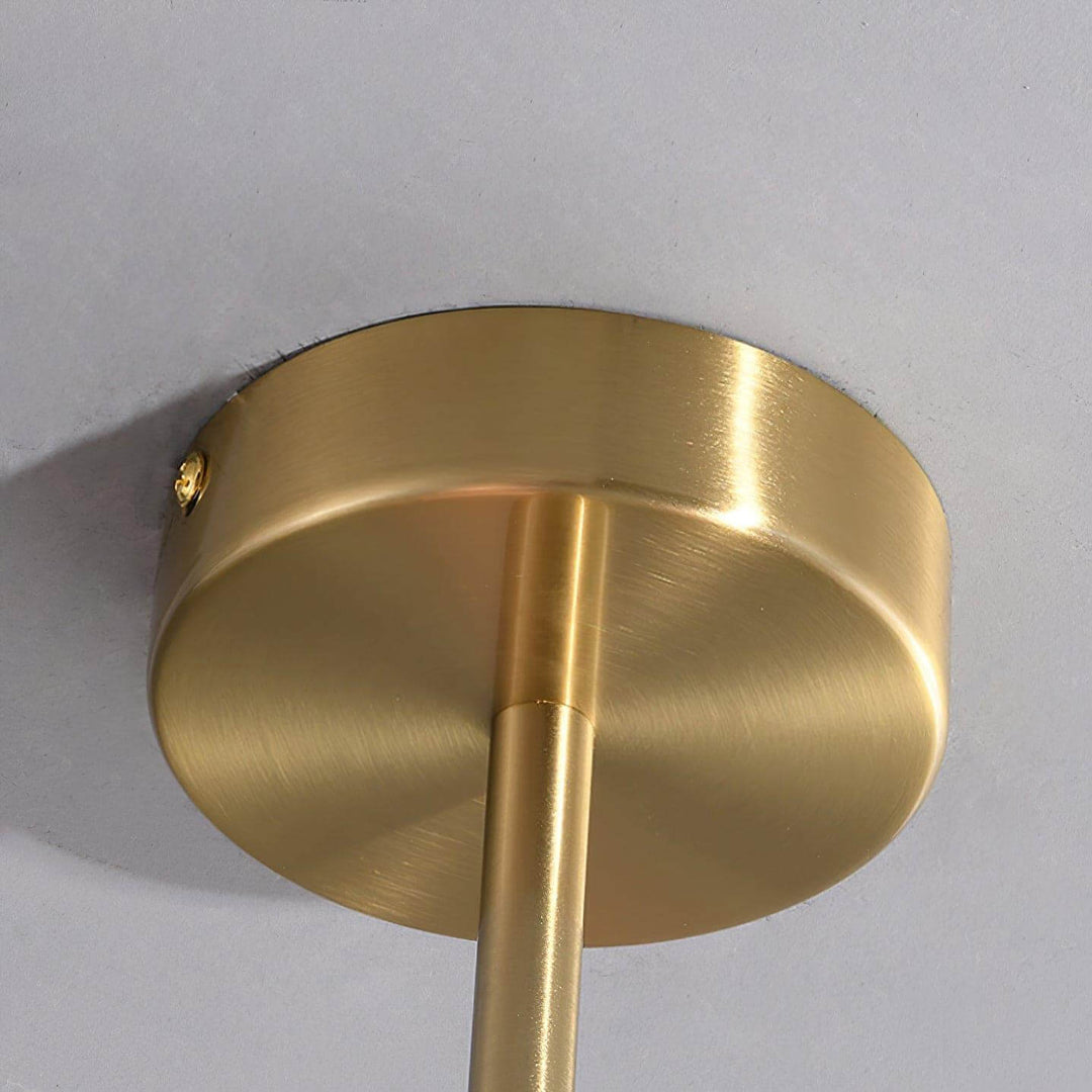 Close-up of the Marshmallow chandelier’s round copper canopy and suspension rod.
