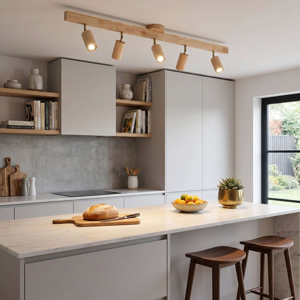 Five-head Merlo wood track lighting installed above a bright modern kitchen island with natural wood cabinetry