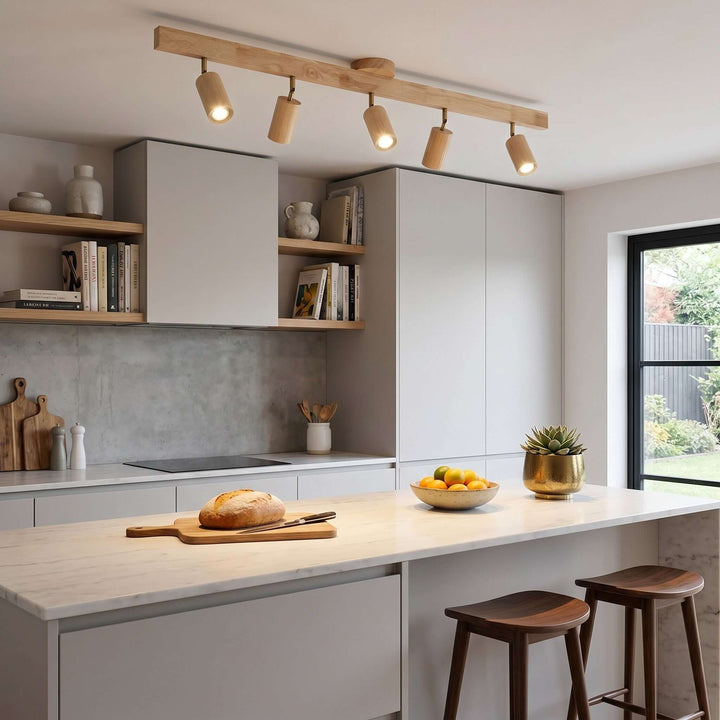 Five-head Merlo wood track lighting installed above a bright modern kitchen island with natural wood cabinetry