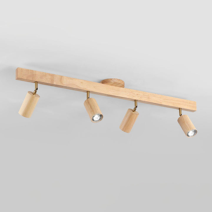 Four-head Merlo natural wood track lighting with adjustable spotlights against a light background