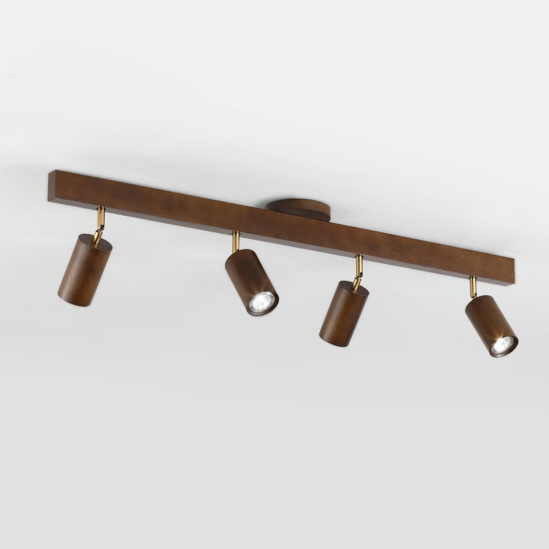 Four-head Merlo walnut wood track lighting with adjustable spotlights in an angled ceiling-mounted view