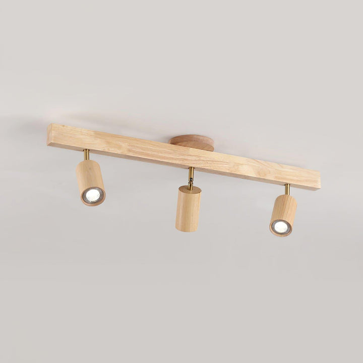 Three-head Merlo natural wood track lighting with adjustable cylindrical spotlights in an angled product view