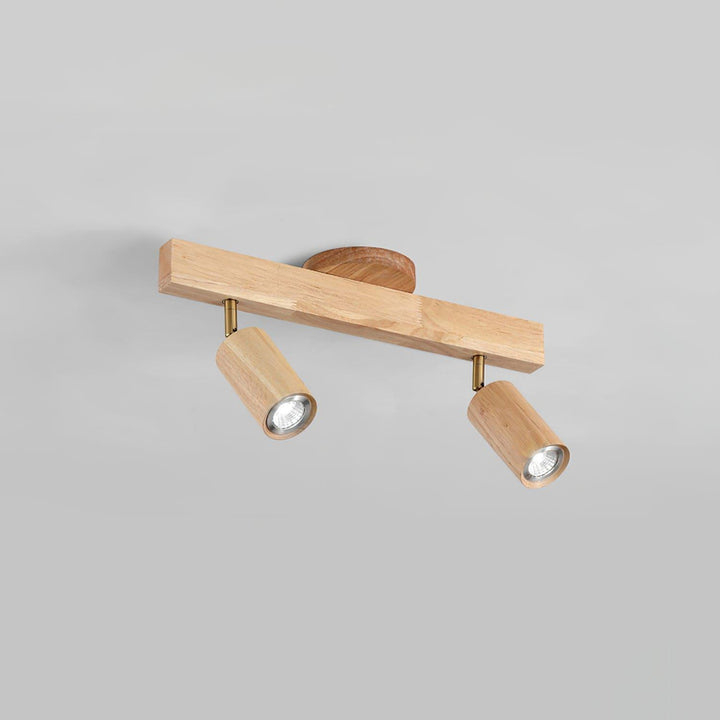 Two-head Merlo natural wood track lighting with adjustable cylindrical spotlights against a light background