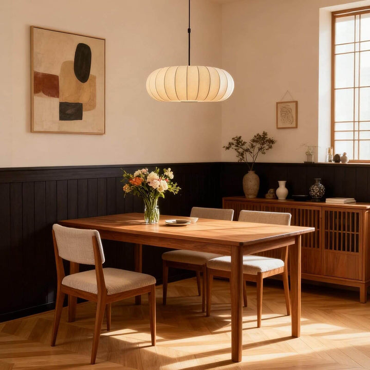Mid-century Verona silk pendant light casting warm light over a wooden dining table