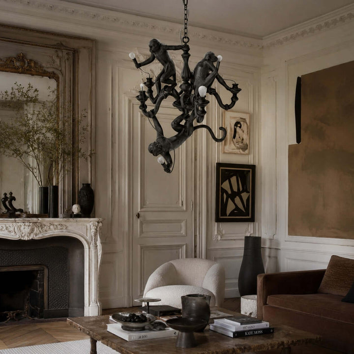 Close interior view of the black Monkey Chandelier in an art-filled living room with a fireplace