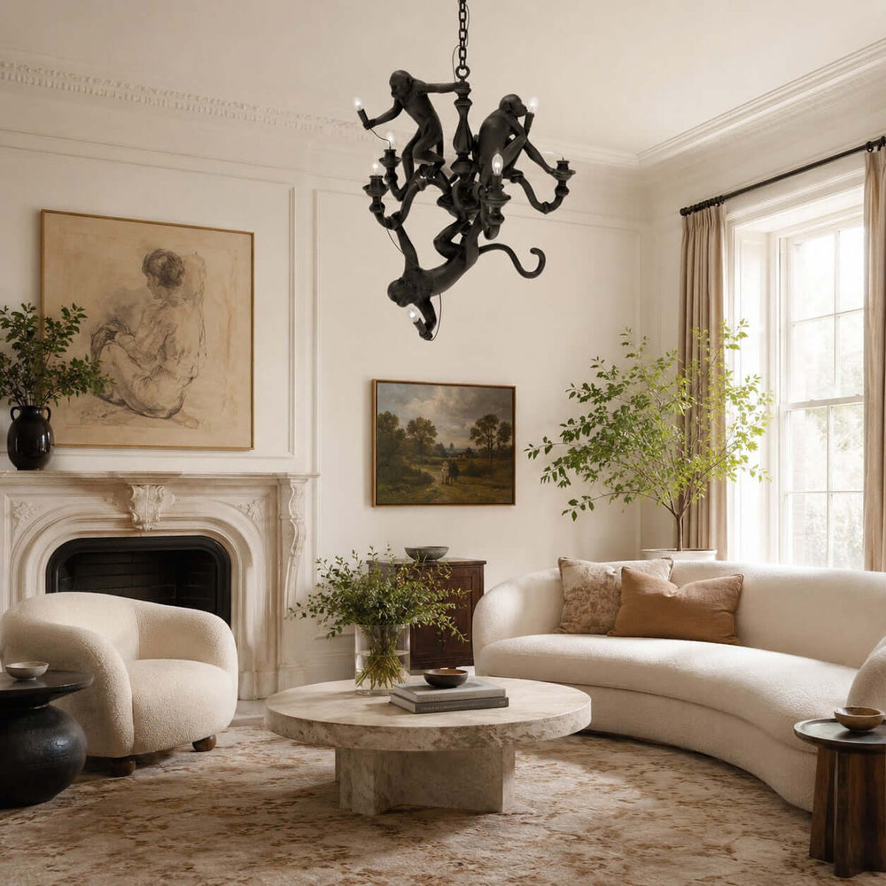 Black Monkey Chandelier hanging above an elegant living room with curved seating and a fireplace