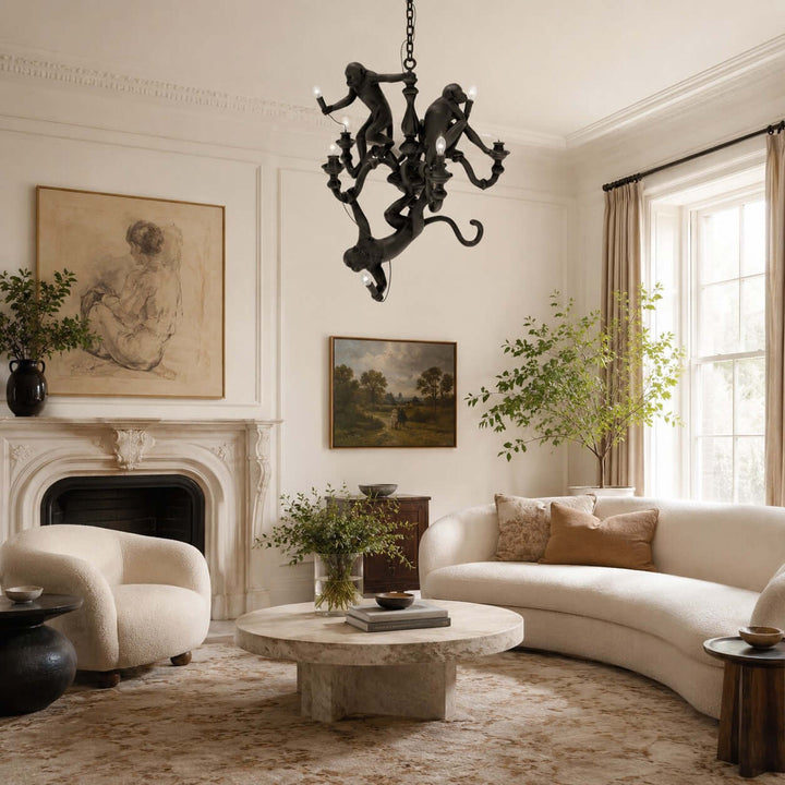 Black Monkey Chandelier hanging above an elegant living room with curved seating and a fireplace