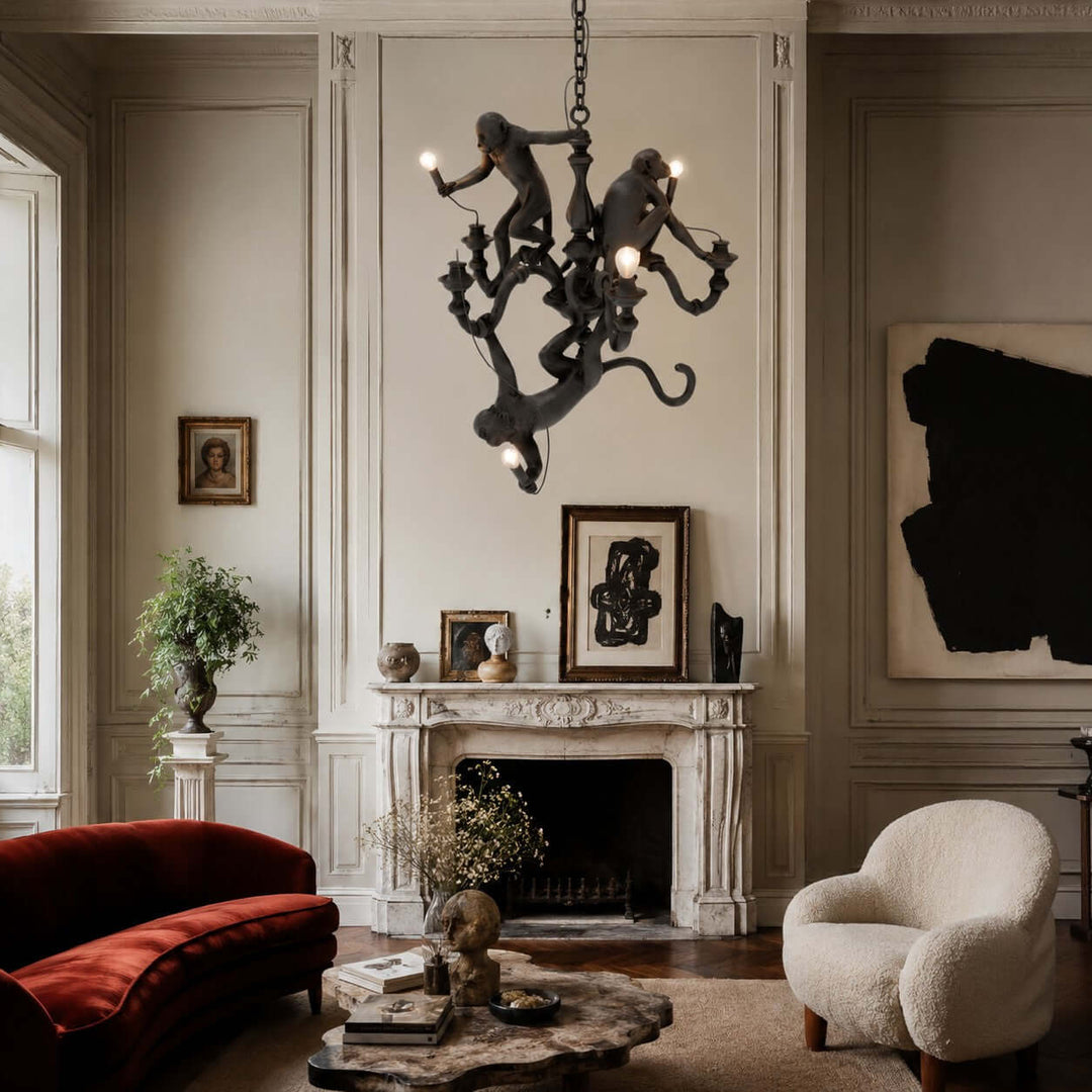 Black Monkey Chandelier above an eclectic living room with a red velvet sofa and marble fireplace