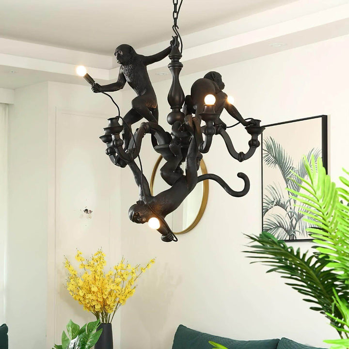 Close view of the black Monkey Chandelier displayed in a modern interior with tropical plants