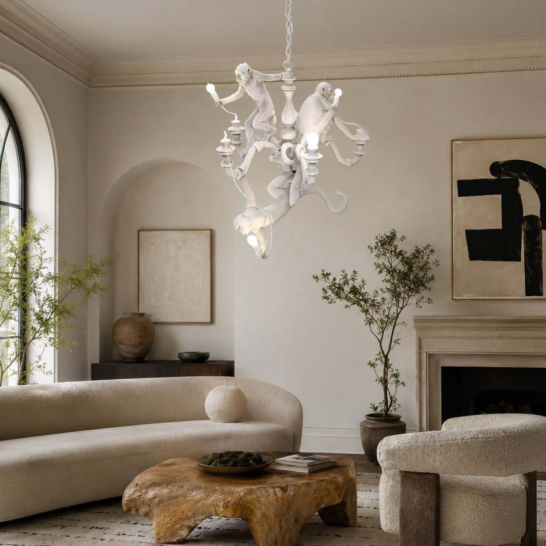 White Monkey Chandelier above an organic modern living room with cream seating and a fireplace