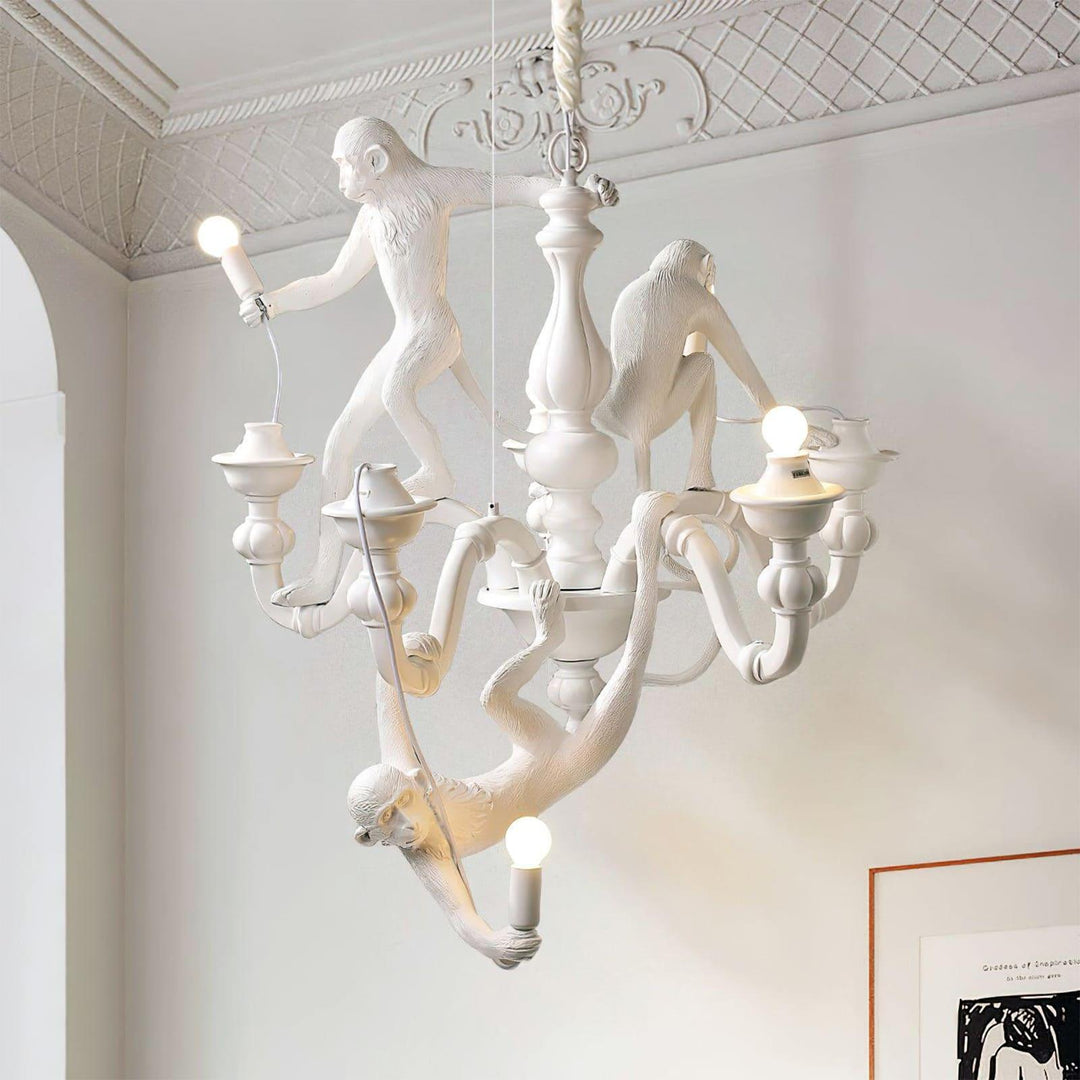 White Monkey Chandelier installed below an ornate ceiling with exposed globe bulbs