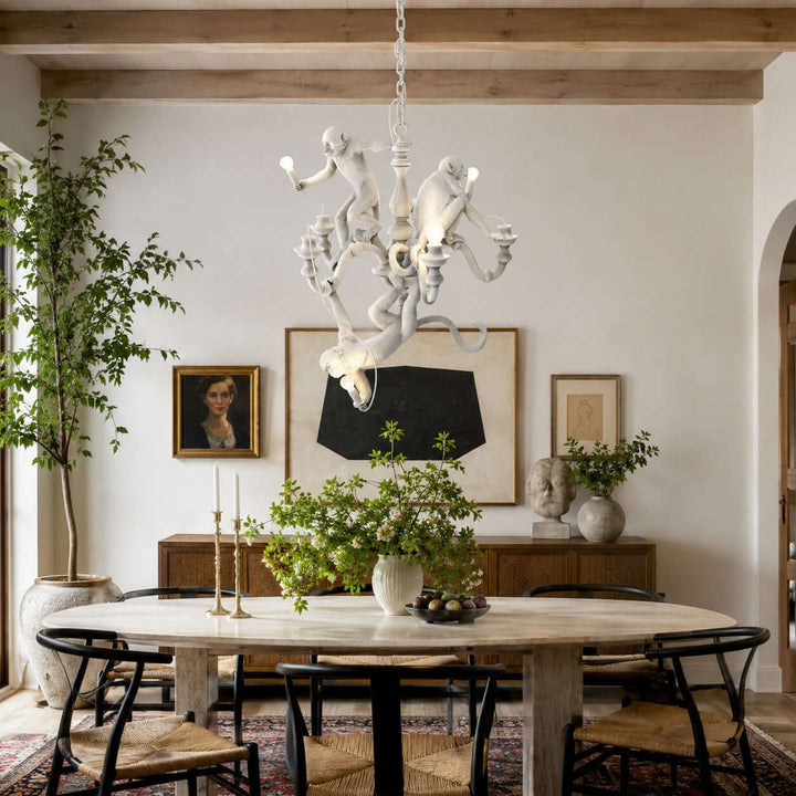 White Monkey dining room chandelier above a rectangular wood table beneath exposed ceiling beams
