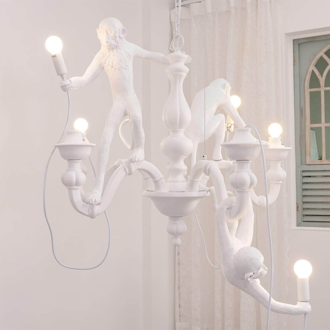 Side view of the white Monkey Chandelier installed near a window in a bright room