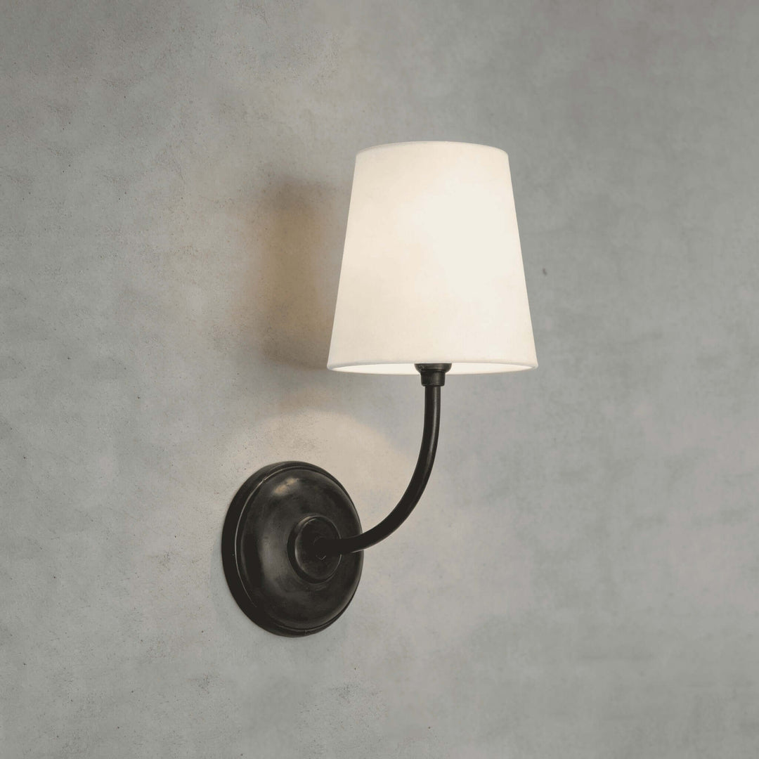 Close-up of the black single-light Multi Wall Sconce with a white fabric shade