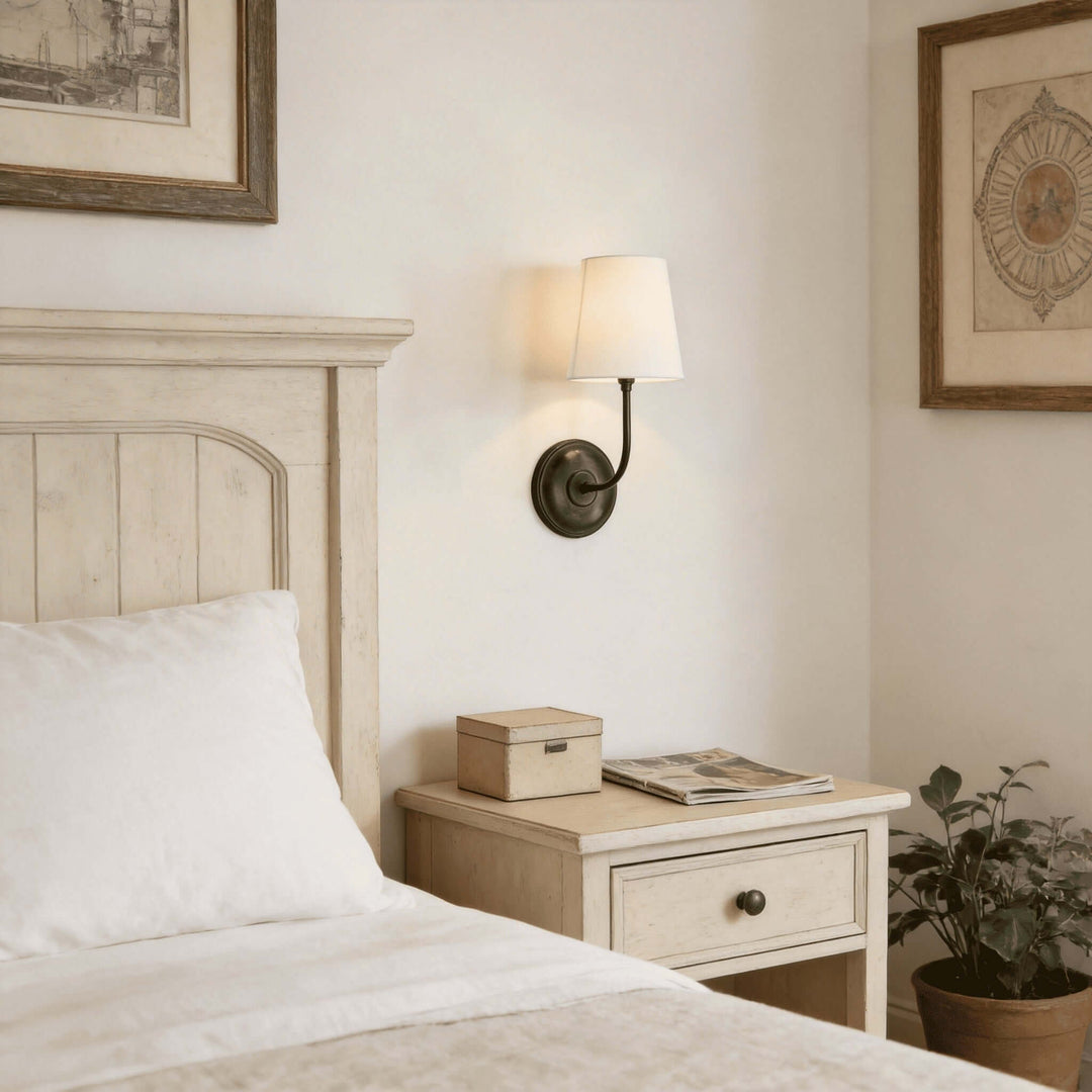Black single-light Multi Wall Sconce with a white shade in a neutral bedroom