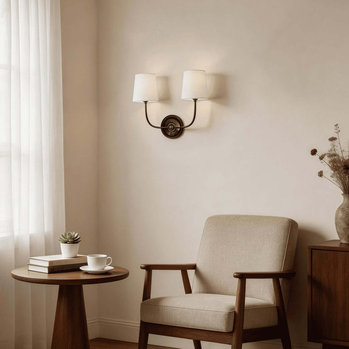 Black two-light Multi Wall Sconce above an armchair in a cozy reading nook