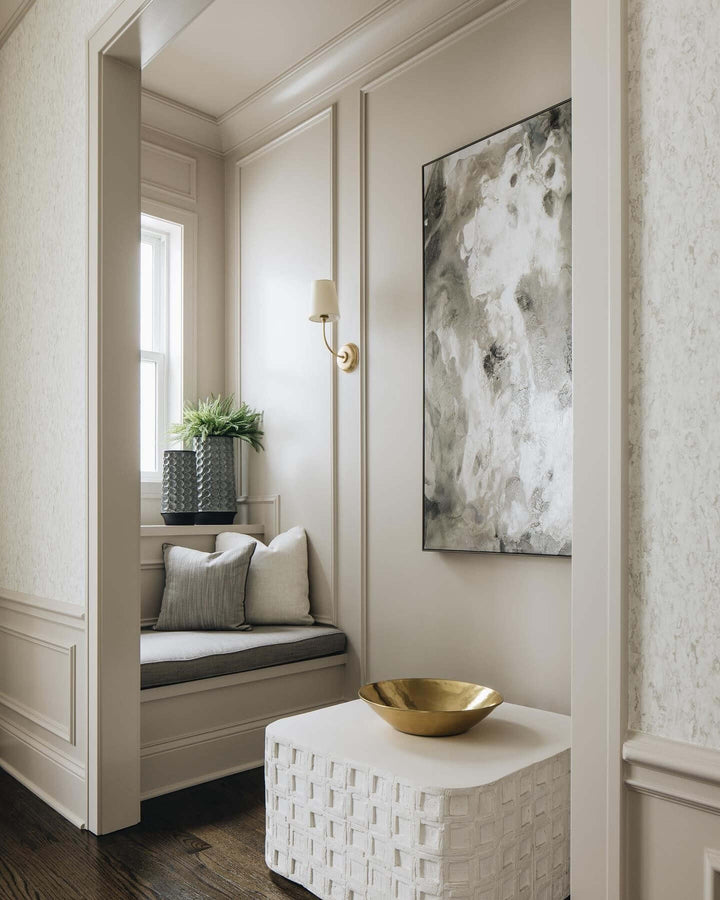 Brass single-light Multi Wall Sconce illuminating an entryway window seat