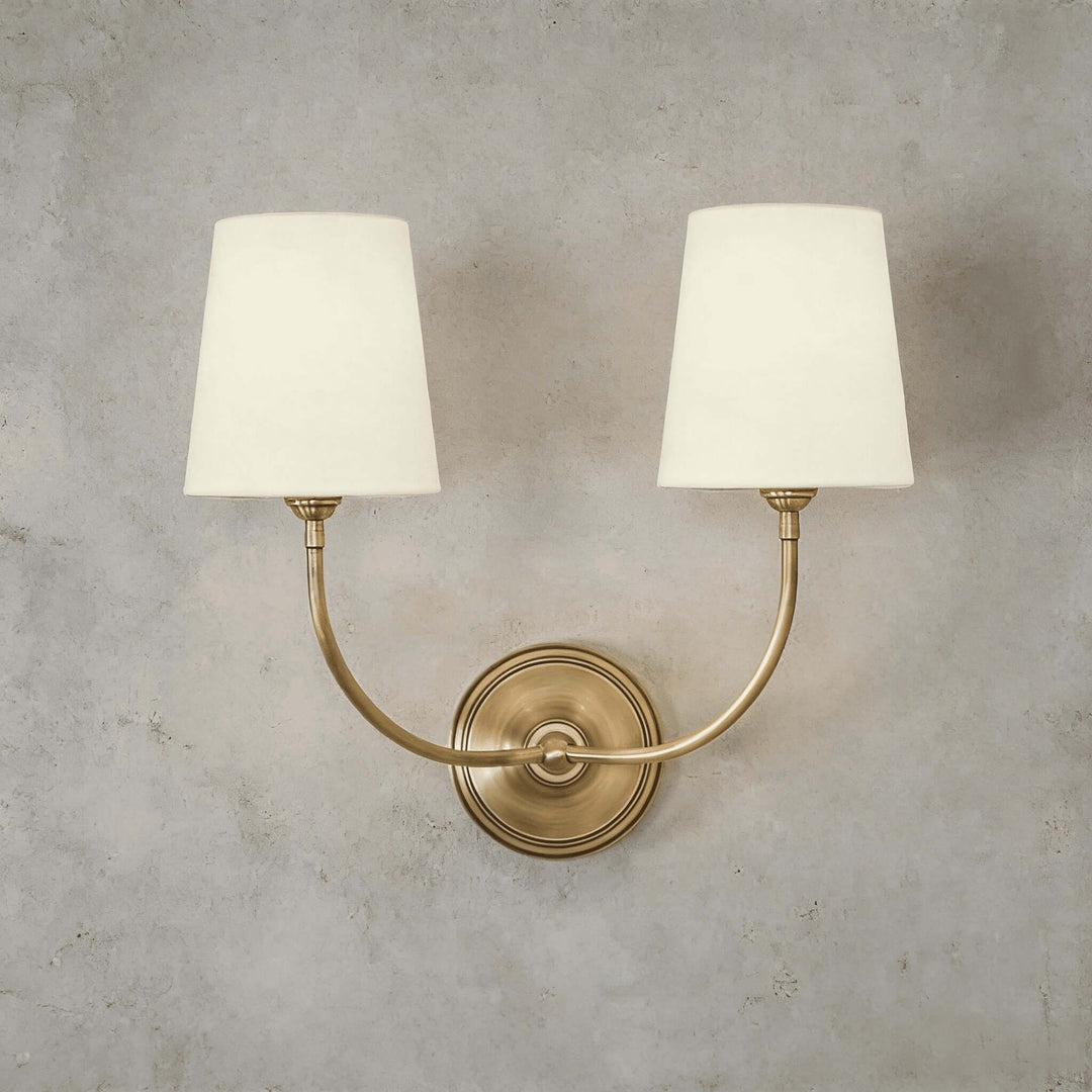 Front view of the brass two-light Multi Wall Sconce with twin fabric shades