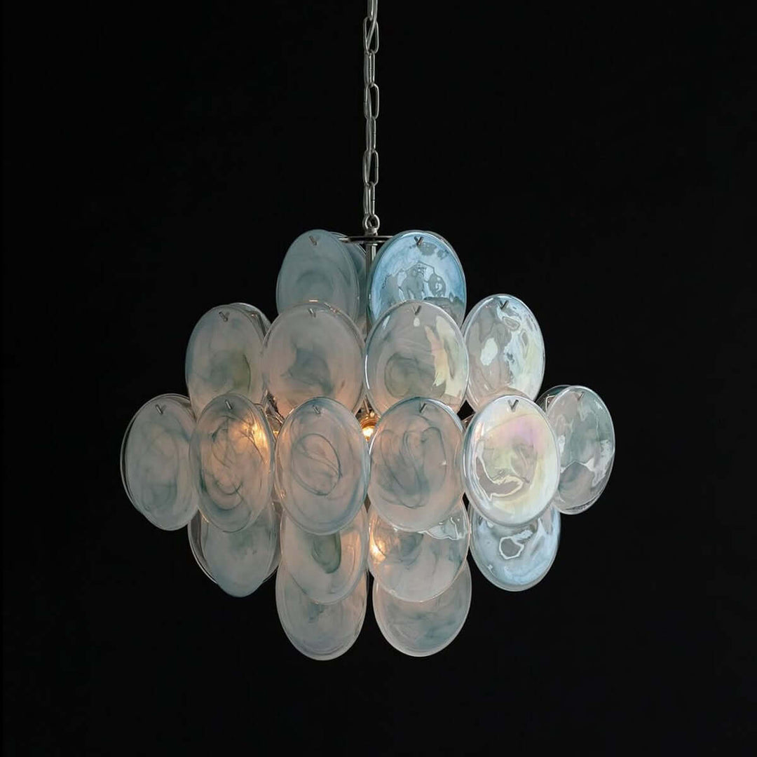 Glowing blue Murano Disk Chandelier with layered iridescent glass discs against a black background