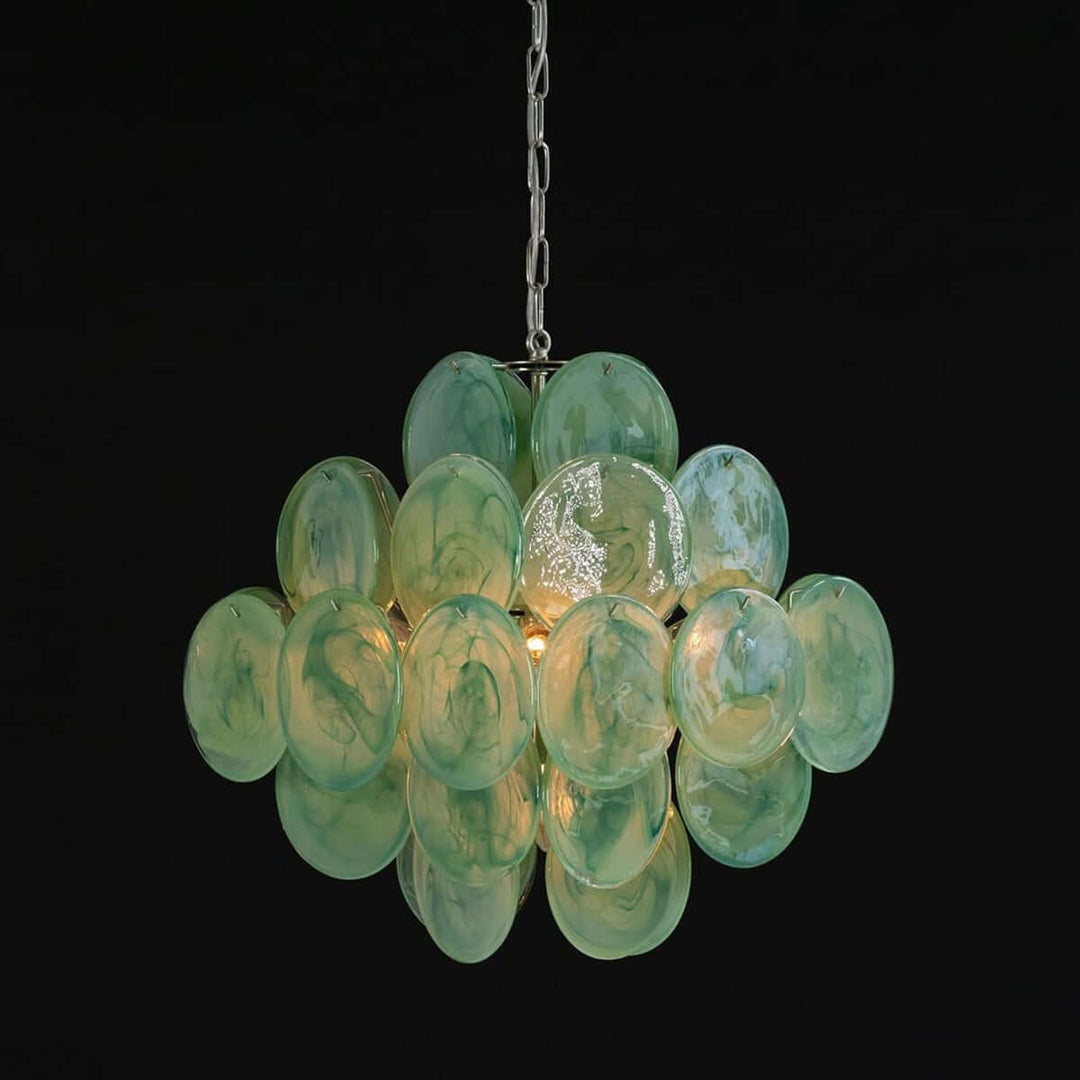 Illuminated green Murano glass chandelier with textured circular discs against a black background