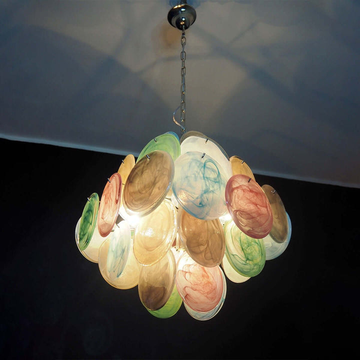 Illuminated multicolor Murano glass chandelier photographed from below against a dark background