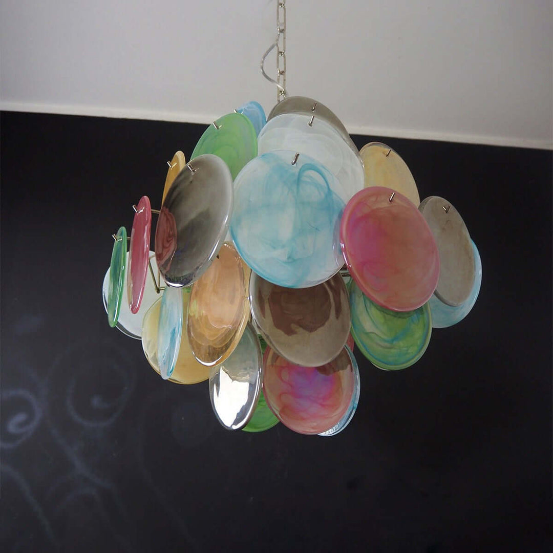 Side view of an unlit multicolor Murano Disk Chandelier against a dark wall