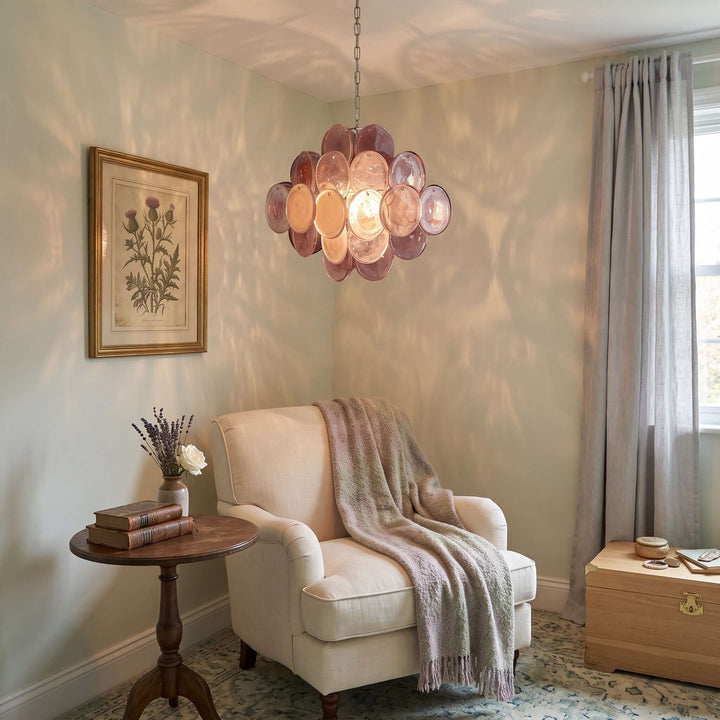 Pink Murano glass chandelier glowing above an upholstered armchair in a cozy reading nook
