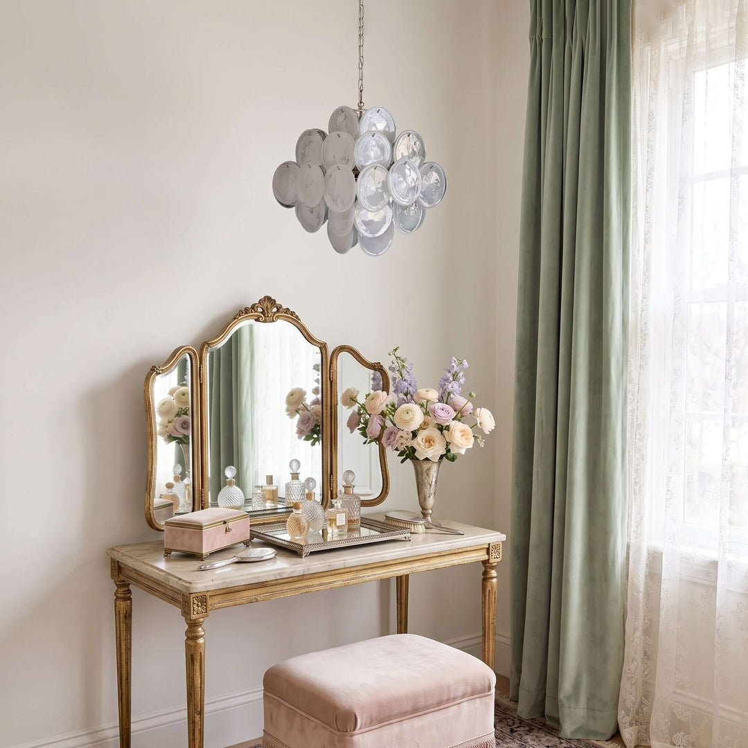 White Murano Disk Chandelier above a vintage dressing table with a gold mirror and fresh flowers